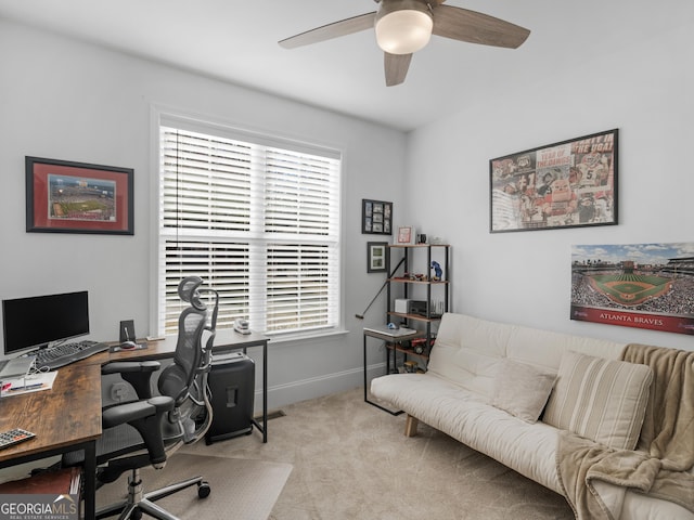 carpeted home office with plenty of natural light and ceiling fan