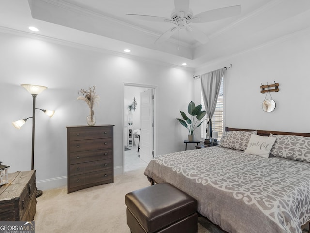 carpeted bedroom with crown molding and a raised ceiling