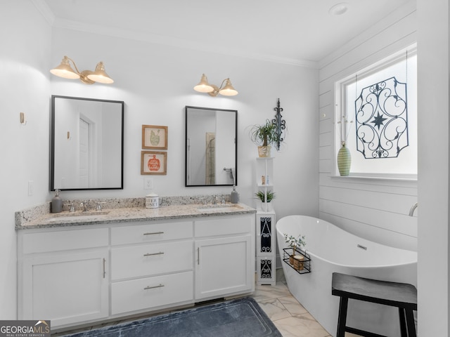 bathroom featuring a bathing tub, vanity, and crown molding