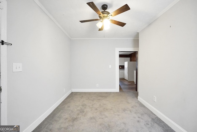 unfurnished room featuring crown molding, light colored carpet, and ceiling fan