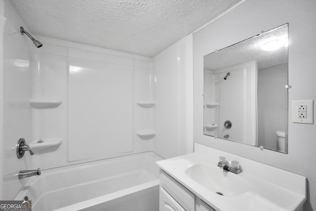 full bathroom featuring vanity, tub / shower combination, toilet, and a textured ceiling