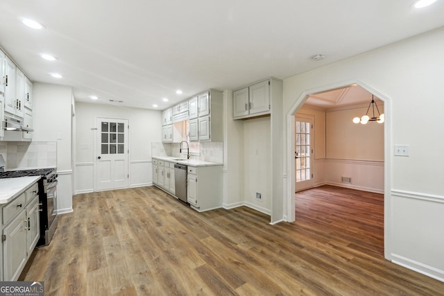 kitchen with white cabinetry, sink, hardwood / wood-style flooring, and appliances with stainless steel finishes