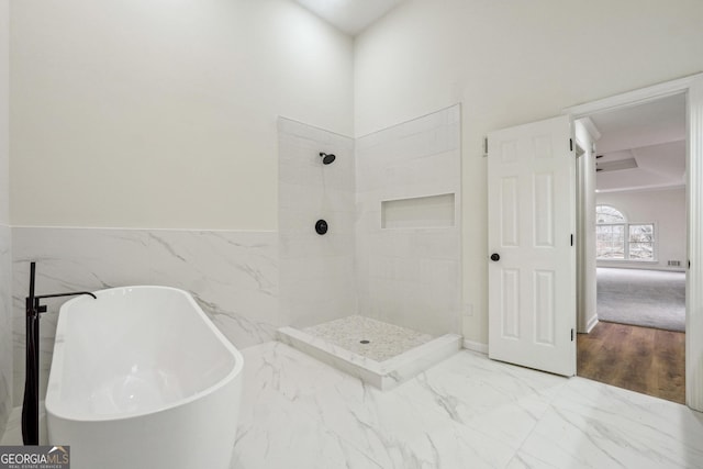 bathroom featuring tile walls and plus walk in shower