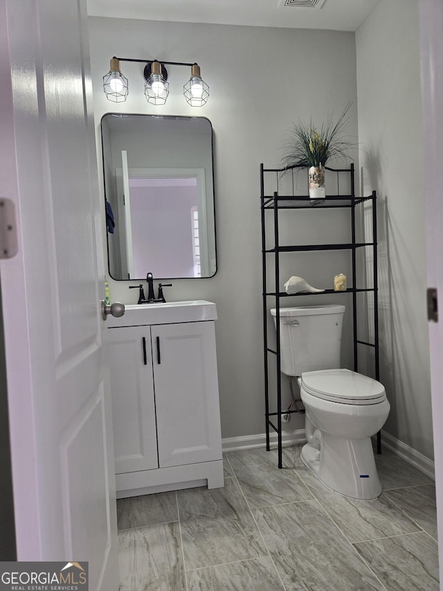 bathroom featuring vanity and toilet