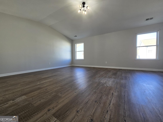 unfurnished room with dark hardwood / wood-style floors and vaulted ceiling