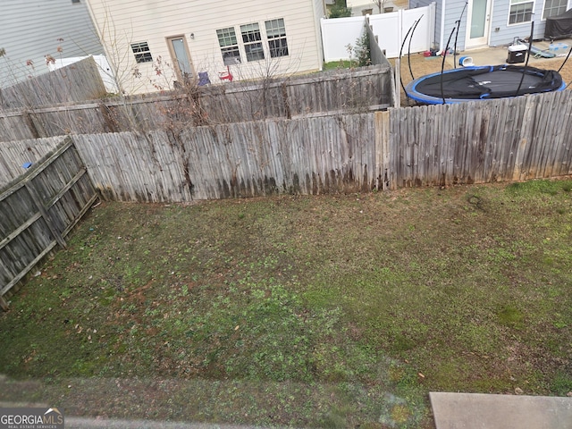 view of yard featuring a trampoline