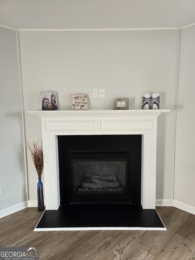 room details with hardwood / wood-style flooring and ornamental molding