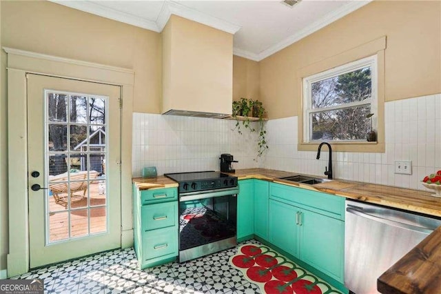 kitchen featuring appliances with stainless steel finishes, wood counters, sink, ornamental molding, and custom range hood