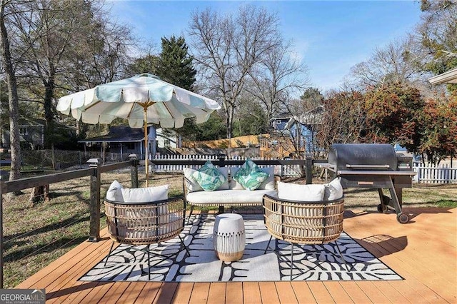 wooden terrace with a grill and outdoor lounge area