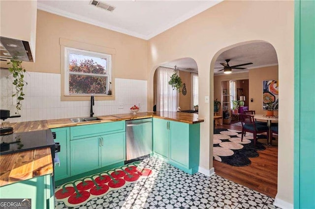 kitchen with sink, crown molding, dishwasher, ceiling fan, and wood counters