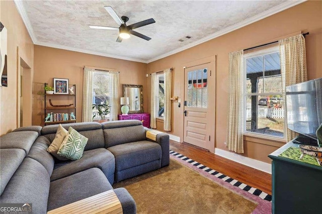 living room with crown molding, wood-type flooring, a textured ceiling, and ceiling fan