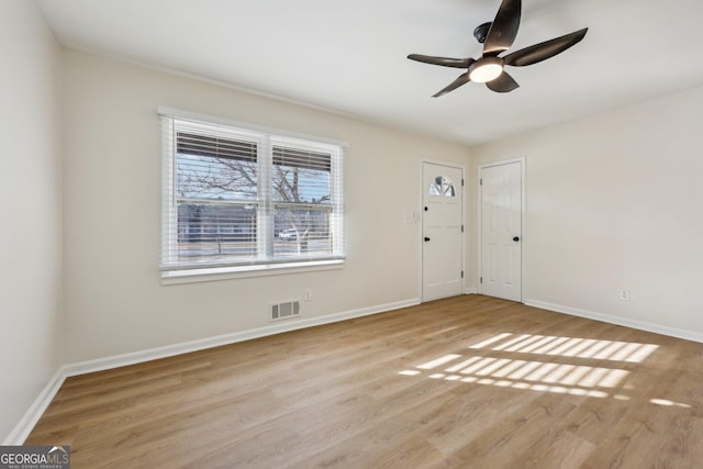 unfurnished room featuring ceiling fan and light wood-type flooring