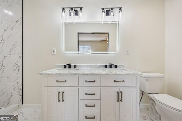 bathroom with walk in shower, vanity, and toilet