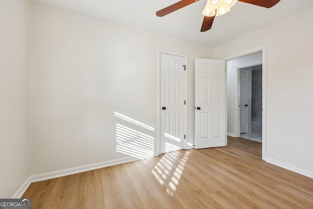 empty room featuring ceiling fan and light wood-type flooring