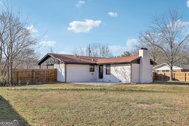 rear view of house with a yard and a patio area