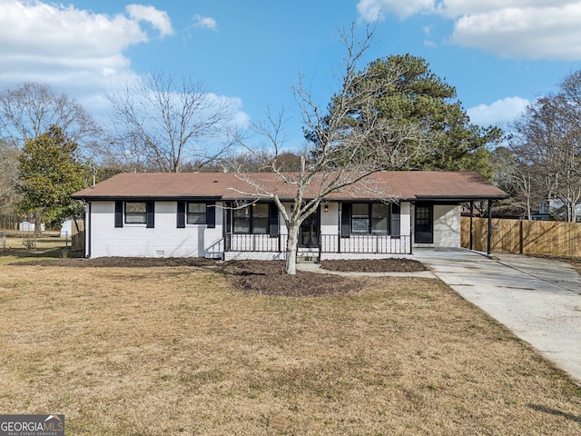 single story home with a front yard, a carport, and covered porch