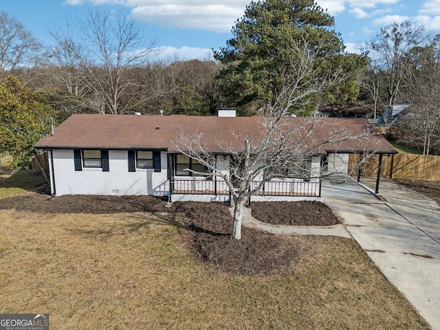 ranch-style house featuring a carport and a front lawn