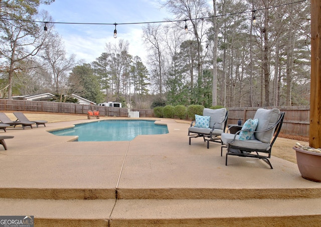 view of swimming pool featuring a patio area