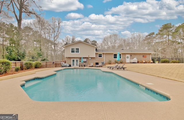 view of pool featuring french doors and a patio area