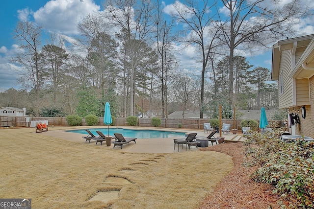 view of pool featuring a patio area and a lawn