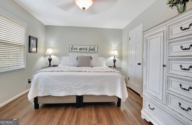 bedroom featuring ceiling fan and hardwood / wood-style floors