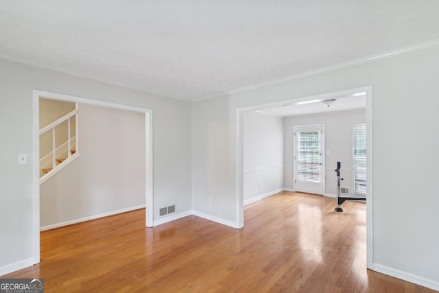 spare room with light hardwood / wood-style flooring and ornamental molding