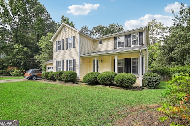 colonial-style house featuring a front lawn