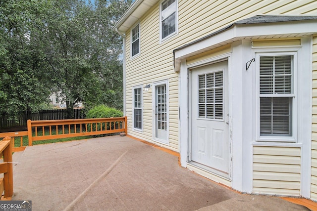 view of exterior entry with a patio