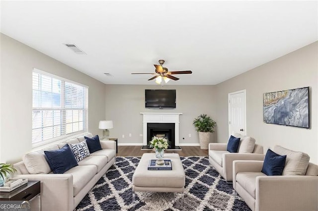 living room featuring hardwood / wood-style flooring and ceiling fan