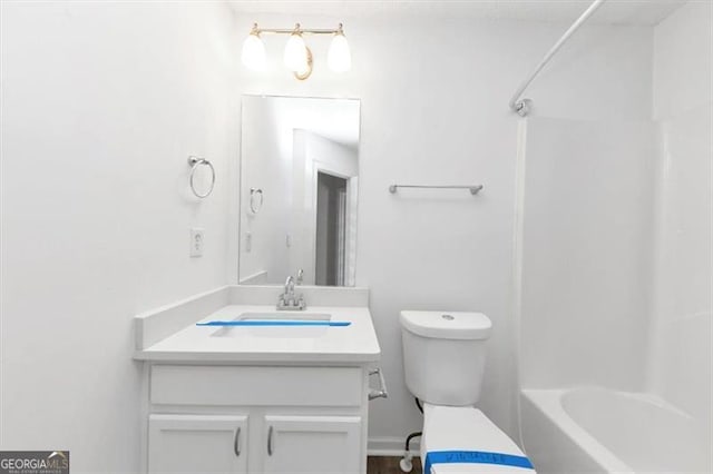 full bathroom featuring vanity, tub / shower combination, and toilet