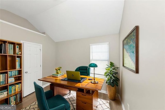 home office with wood-type flooring and vaulted ceiling