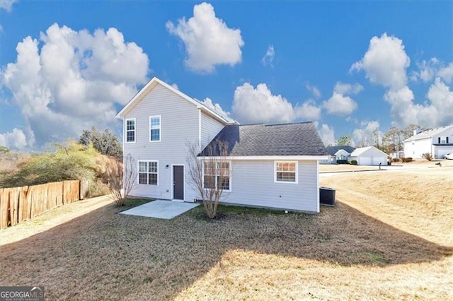 back of property featuring cooling unit, a yard, and a patio