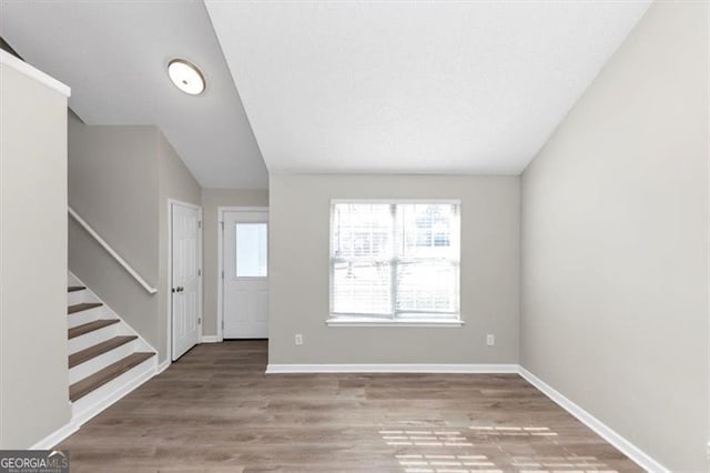 foyer featuring hardwood / wood-style flooring and lofted ceiling