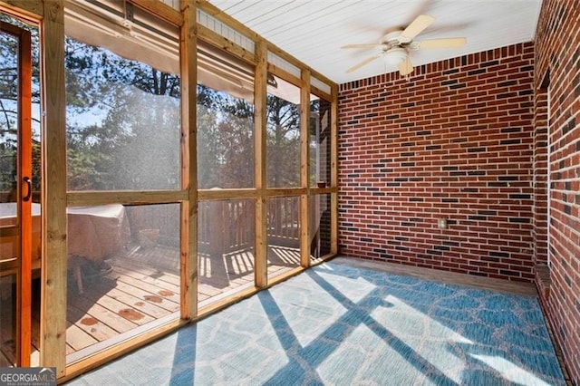 unfurnished sunroom with ceiling fan