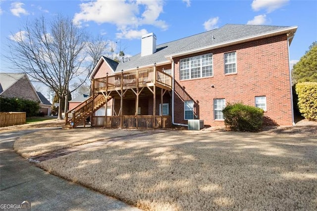 rear view of house with cooling unit and a deck