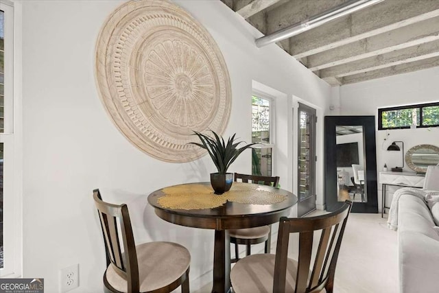 dining room featuring beamed ceiling