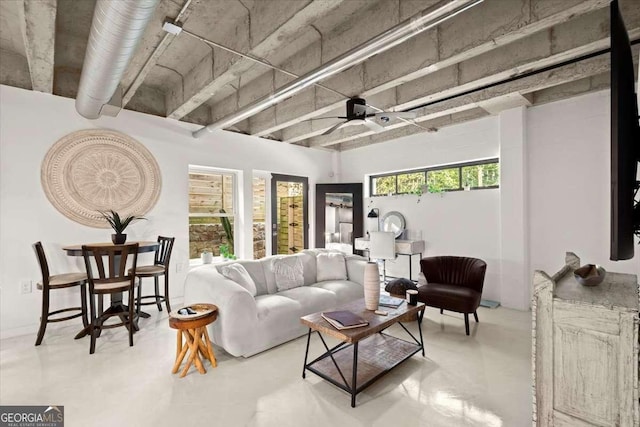 living room with ceiling fan and concrete floors