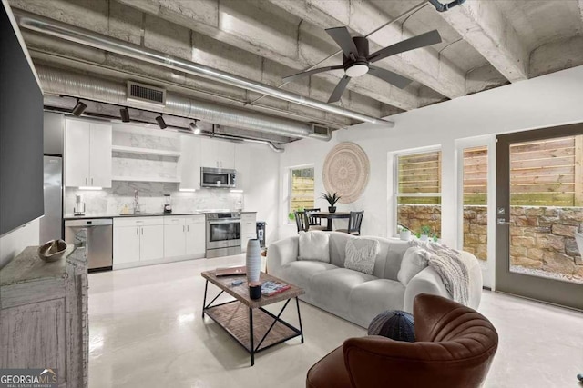 living room featuring sink and ceiling fan