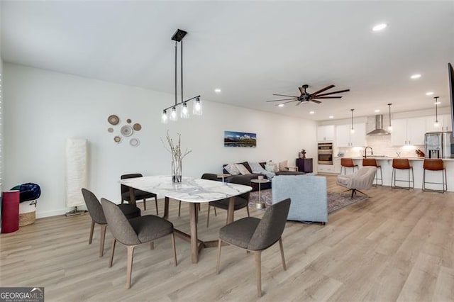 dining area featuring light hardwood / wood-style floors and ceiling fan