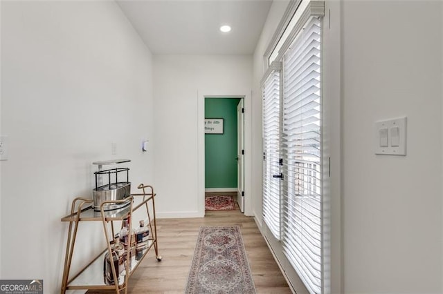 hall with light hardwood / wood-style floors