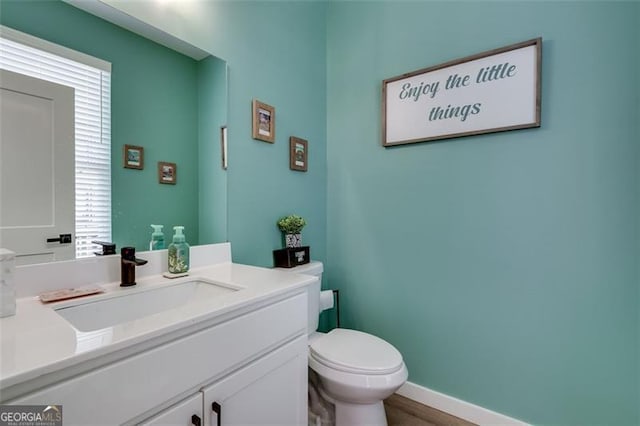 bathroom featuring vanity and toilet