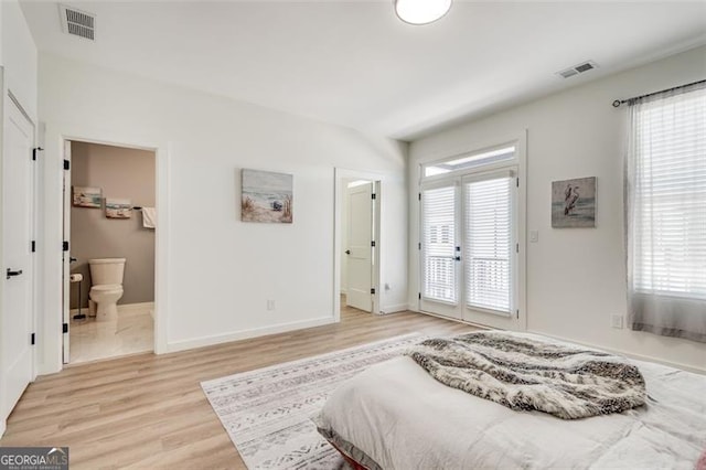 bedroom with access to outside, connected bathroom, and light hardwood / wood-style flooring