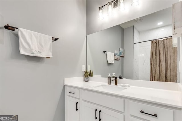 bathroom featuring vanity and a shower with shower curtain