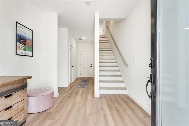 foyer entrance with light wood-type flooring