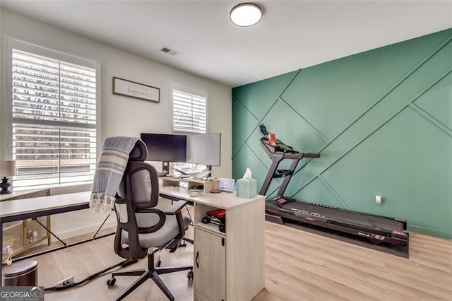 home office with wood-type flooring