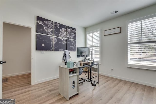 office space with light wood-type flooring