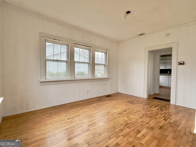 empty room with light hardwood / wood-style floors