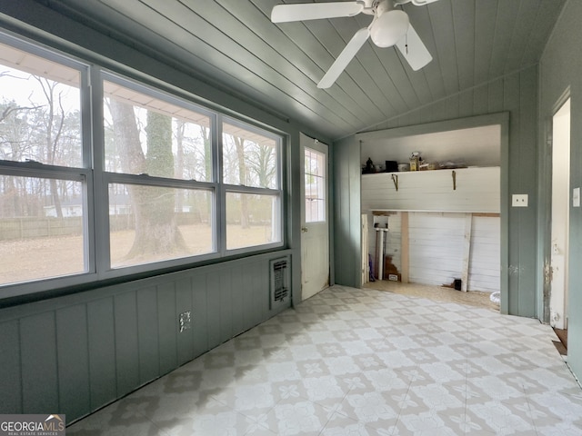 unfurnished sunroom with lofted ceiling, wood ceiling, and ceiling fan