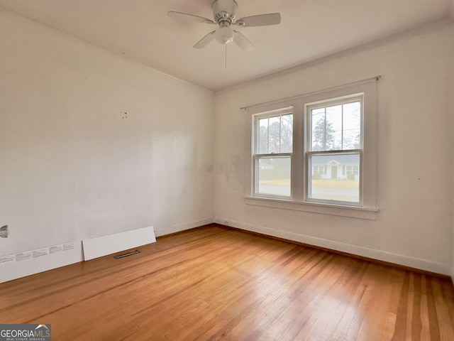 unfurnished room with ceiling fan and light wood-type flooring