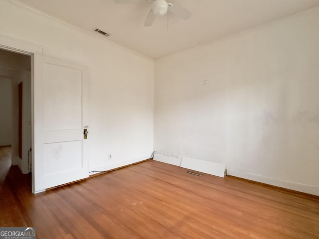 spare room with hardwood / wood-style flooring and ceiling fan